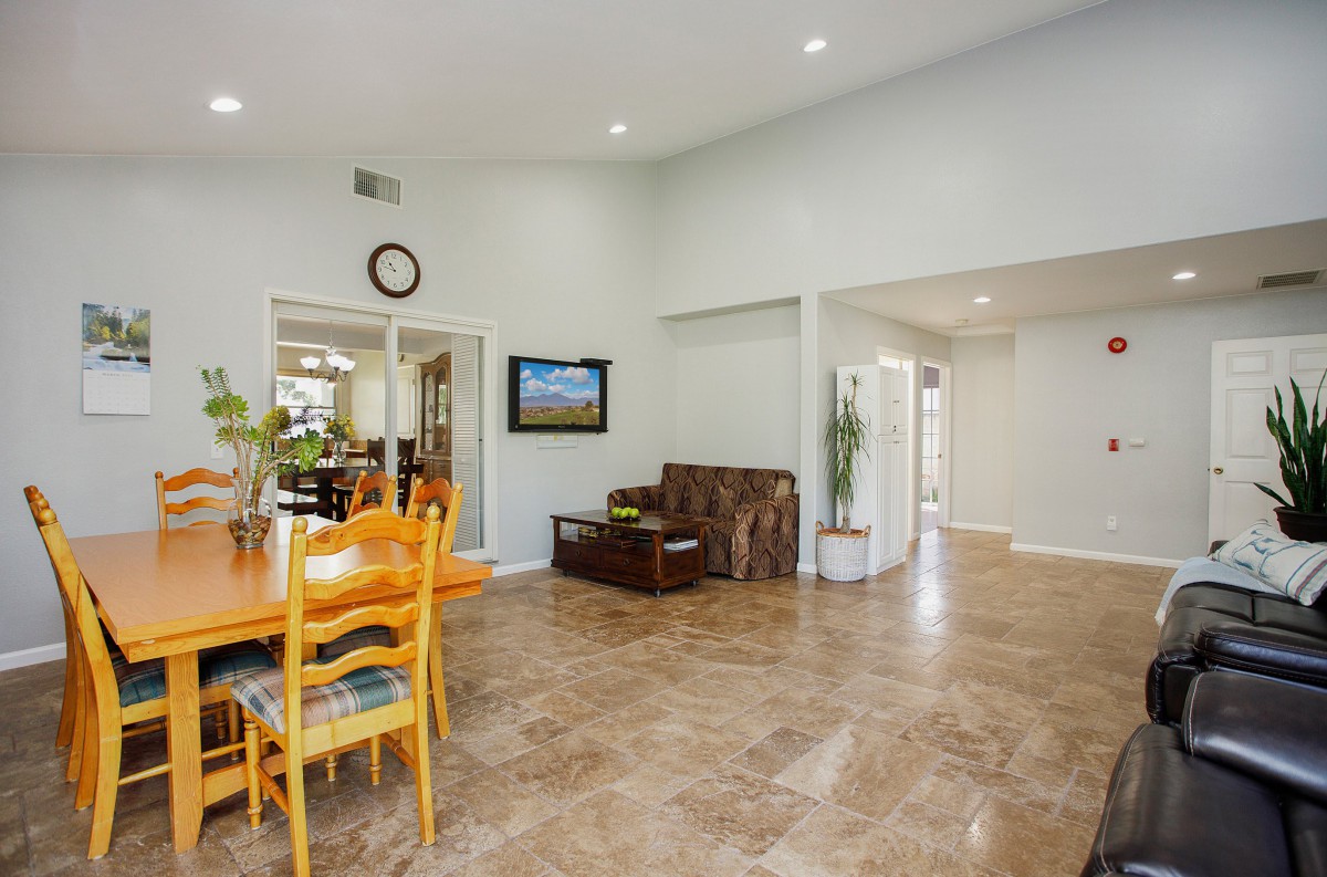 Spacious living and dining area with tiled flooring and cozy seating.