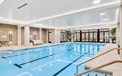 A luxurious indoor swimming pool with modern decor and large glass windows.