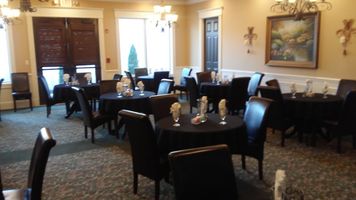 An elegant dining room with neatly arranged tables and chairs, ready for guests.
