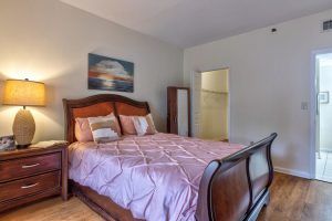 A cozy bedroom with a large bed and wall artwork.