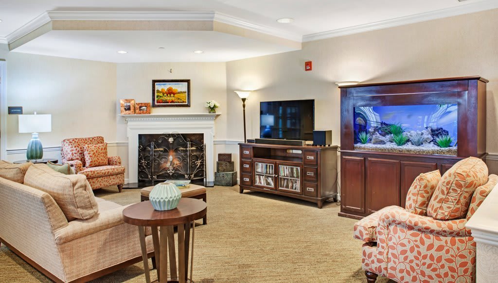 A cozy living room with a fireplace, television, and comfortable seating.