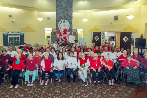 A vibrant gathering of seniors in red attire, showcasing community spirit and togetherness.