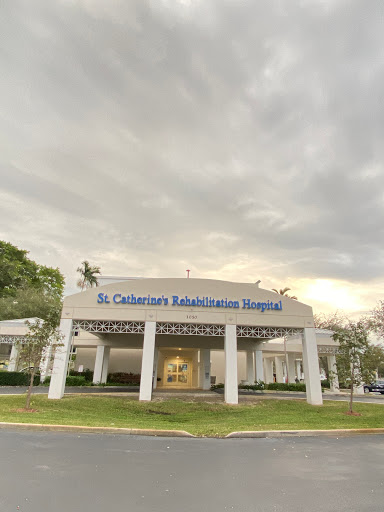A view of St. Catherine's Hospital, showcasing its modern architecture against a cloudy sky.