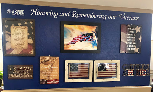 A tribute wall dedicated to honoring and remembering our veterans, featuring various artistic representations of the American flag.