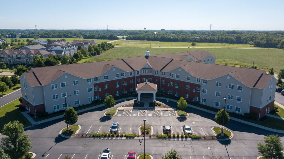 Aerial view of a suburban residential building with a parking lot.
