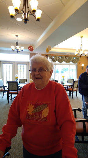 A joyful elderly woman enjoying her time in a seniors living community.