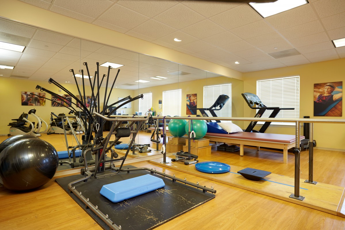 A well-equipped gym with a variety of exercise machines and fitness tools.