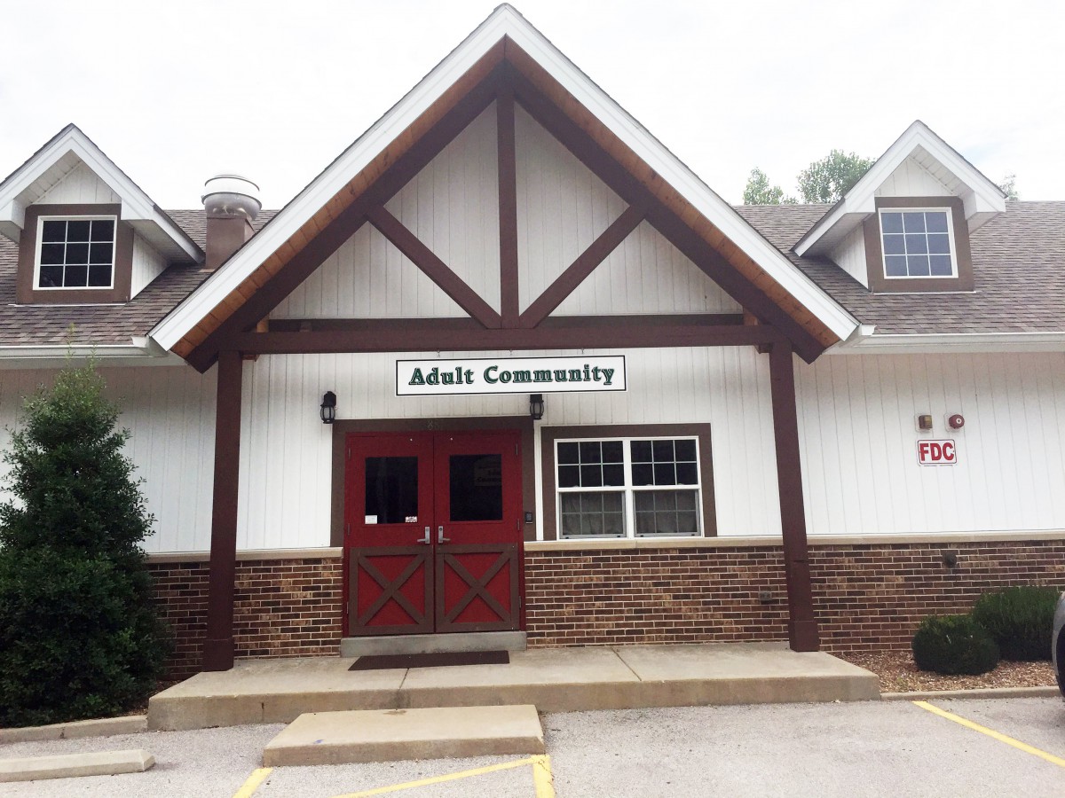 The entrance to a community center with a sign above the door.