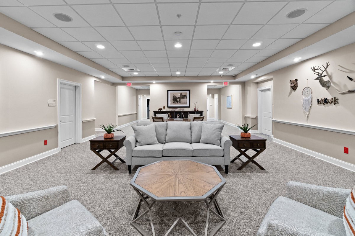 A modern living room with neutral colors and cozy furniture.