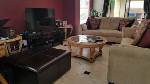 A cozy living room featuring a stylish coffee table, comfortable sofa, and a television setup.