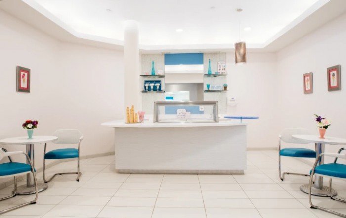 A modern and minimalist reception desk area with white and blue accents.