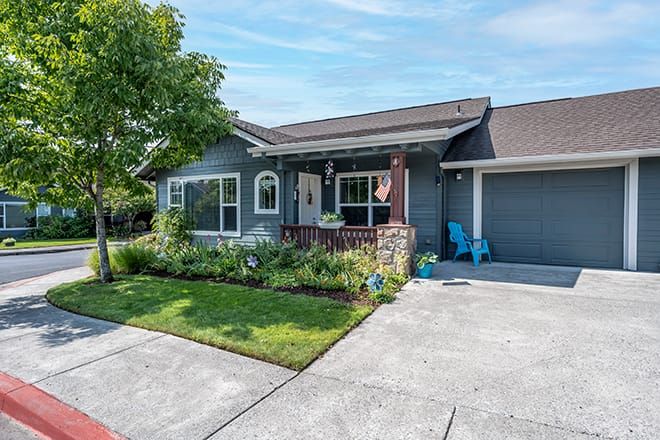 A suburban house with a well-maintained front yard and a driveway.