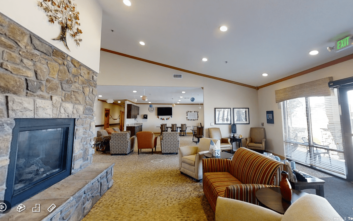 A cozy living room with comfortable seating, a fireplace, and warm lighting.