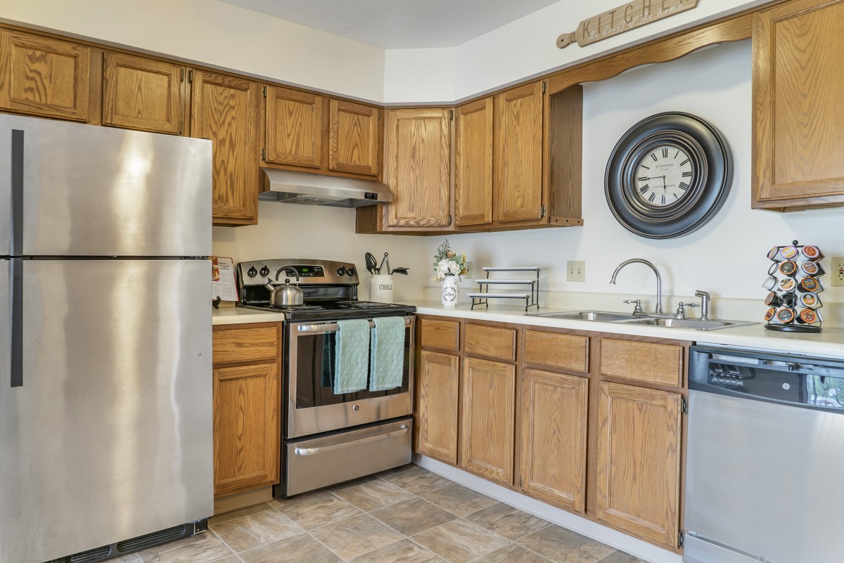 A modern kitchen with wooden cabinets and stainless steel appliances.