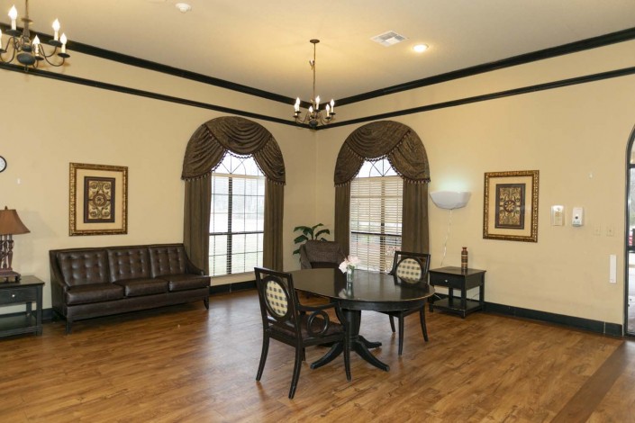 A well-lit office waiting area with elegant furnishings and large windows.