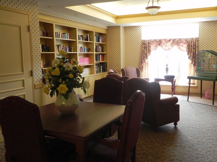 A cozy reading room with bookshelves and comfortable seating.