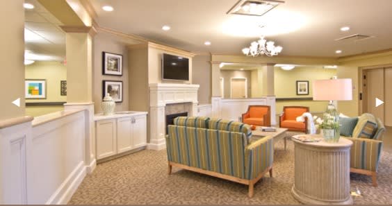 A cozy living room with a fireplace, television, and comfortable seating.