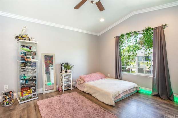 A cozy minimalist bedroom with natural light and a touch of greenery.