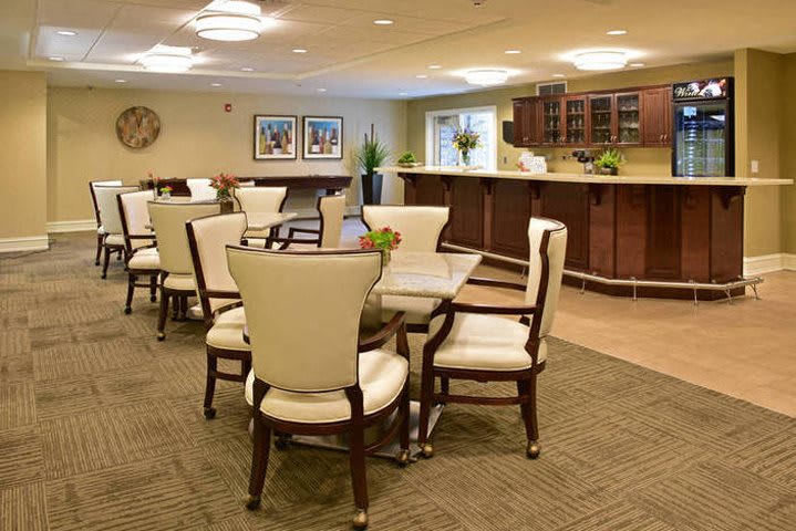 A modern dining room with elegant furniture and soft lighting.
