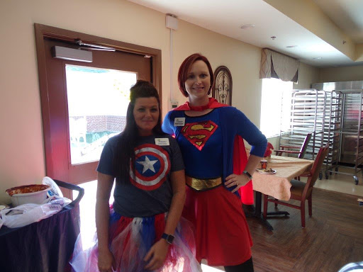 Two individuals dressed in superhero costumes, showcasing their playful spirit.