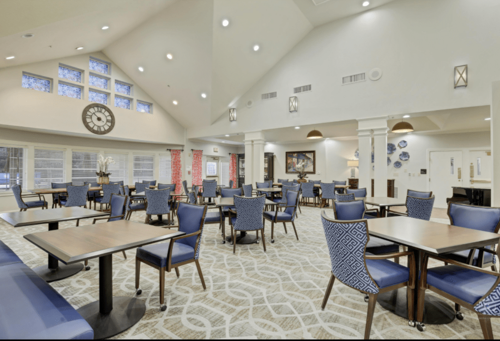 A spacious and modern dining area with neatly arranged tables and chairs.