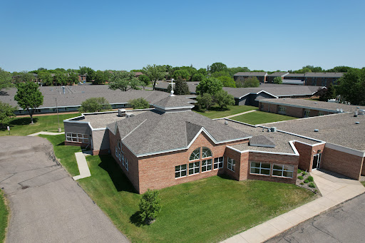 Aerial view of a school campus surrounded by greenery.