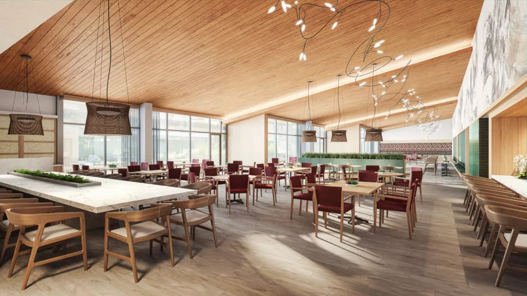 A modern restaurant interior with wooden ceilings and elegant lighting, featuring empty tables ready for dining.