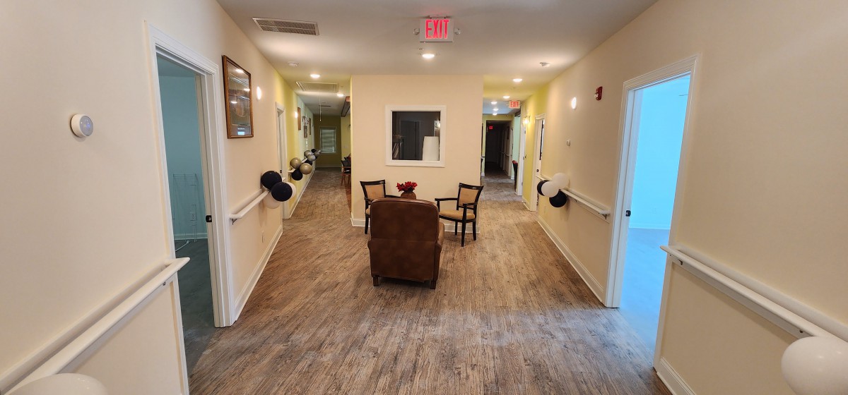 A cozy hallway with seating area, featuring chairs and a table.