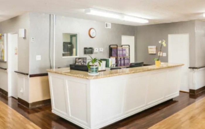 A modern reception desk in an office waiting area.