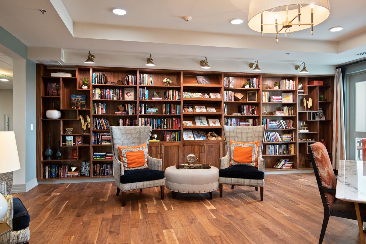 A cozy reading area with comfortable chairs surrounded by bookshelves in a library.