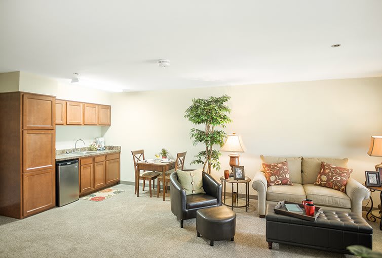 A cozy open-plan apartment with a kitchen, dining area, and comfortable seating.