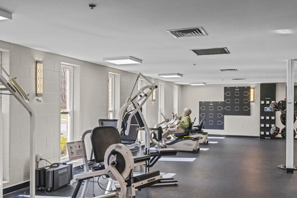 A modern gym equipped with various exercise machines and workout facilities.
