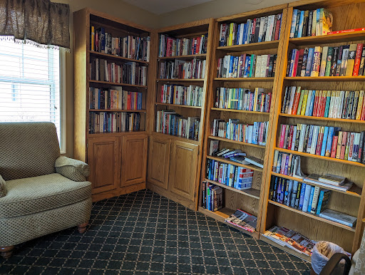 A cozy reading corner featuring bookshelves filled with various books.