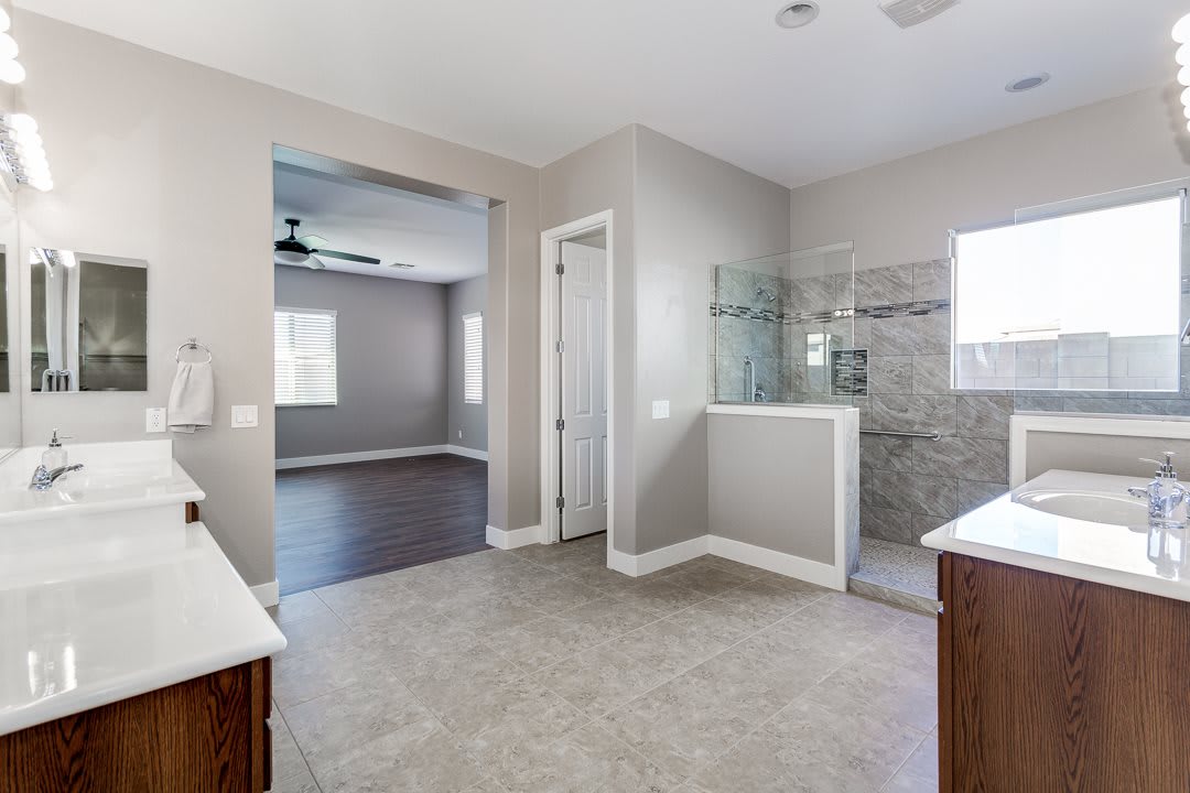 A modern bathroom with a spacious shower and tile flooring.