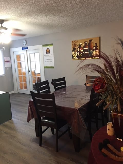 A cozy dining room with a table, chairs, and wall decor.