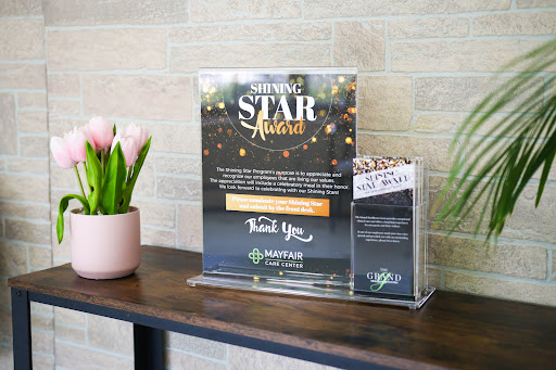 Promotional display for a star-themed event with a thank-you note, complemented by decorative flowers.