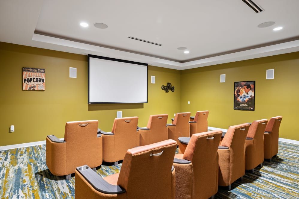 A cozy home theater with comfortable seating and a large projection screen.