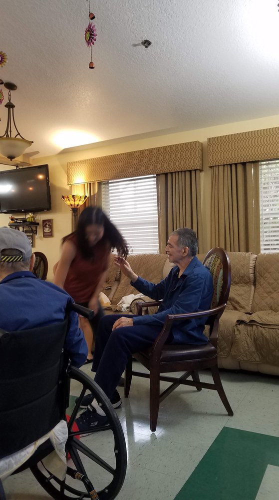 A group of people interacting in a cozy living room setting.