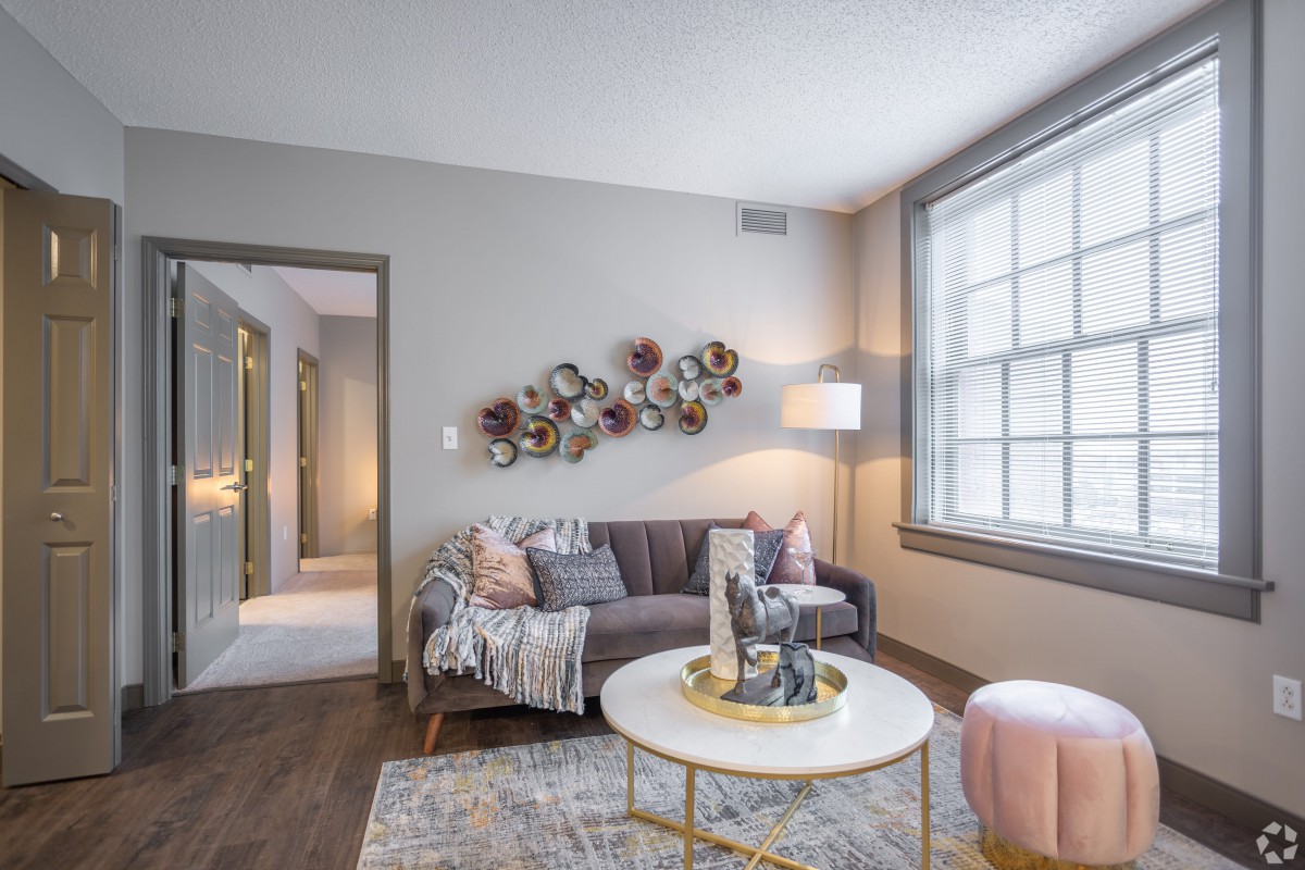 A cozy living room featuring a modern sofa, stylish coffee table, and decorative wall art.