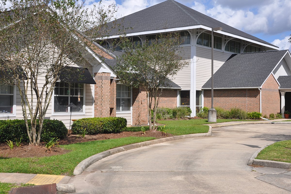 A suburban residential building with well-maintained landscaping.
