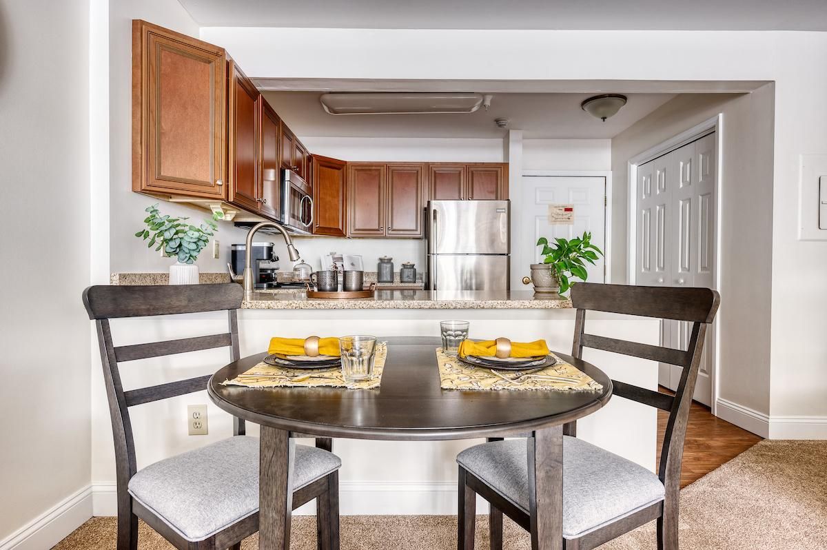 Modern kitchen and dining area with a cozy table setting.