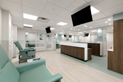 A modern and inviting healthcare clinic waiting area with comfortable seating and a reception desk.