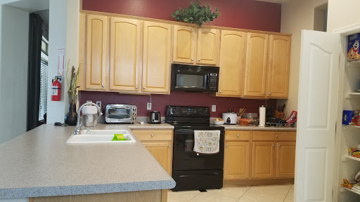 A well-organized kitchen featuring wooden cabinets and modern black appliances.
