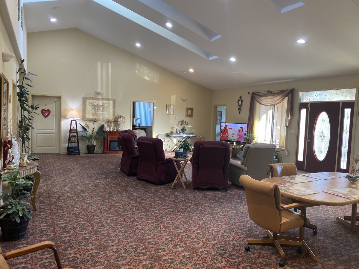 A spacious living room with recliner chairs and a television.
