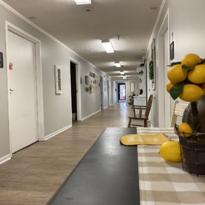 A hallway with decorative lemons on a table.