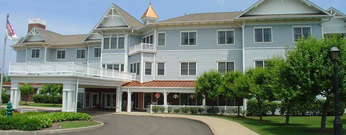 A large residential building with a welcoming entrance and multiple windows.