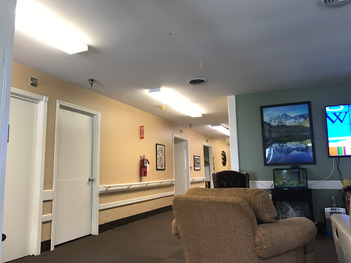 A quiet lobby area with seating and a view of the hallway.
