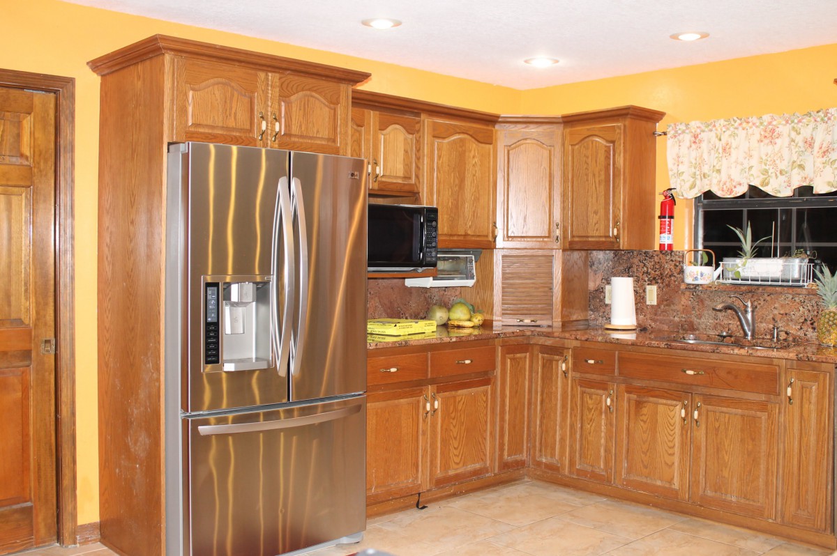 A modern kitchen featuring wooden cabinets and stainless steel appliances.