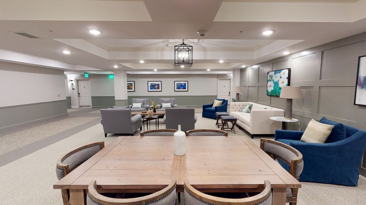 A modern lounge area with comfortable seating, tables, and contemporary decor.
