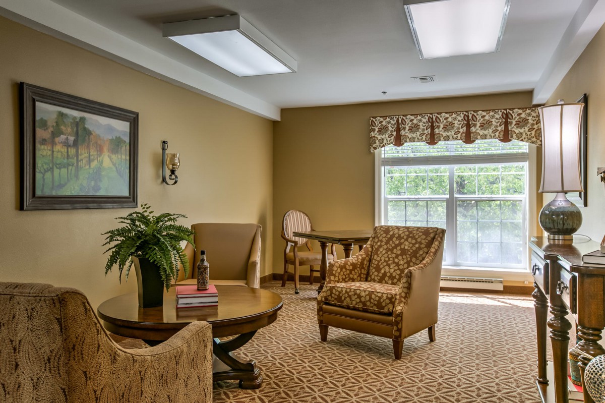 A cozy living room with elegant furniture and a large window.